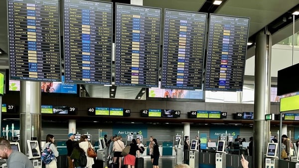 Passengers at Aer Lingus desks at Dublin Airport's Terminal 2 this morning